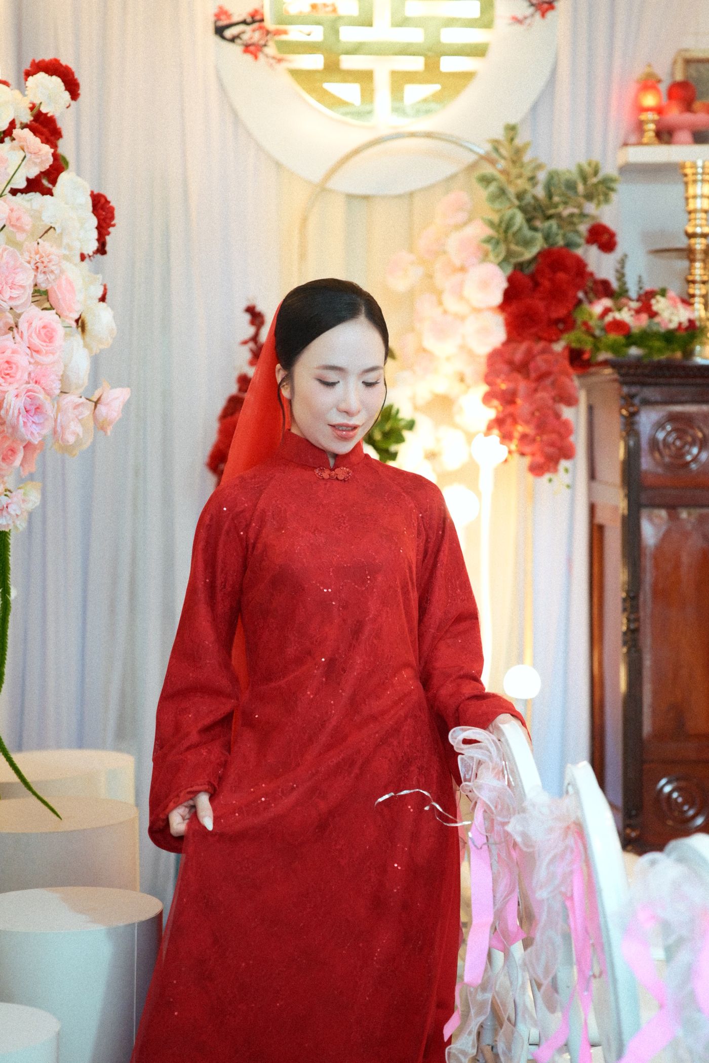 Woman in elegant traditional Chinese red Hanfu gown at a celebration